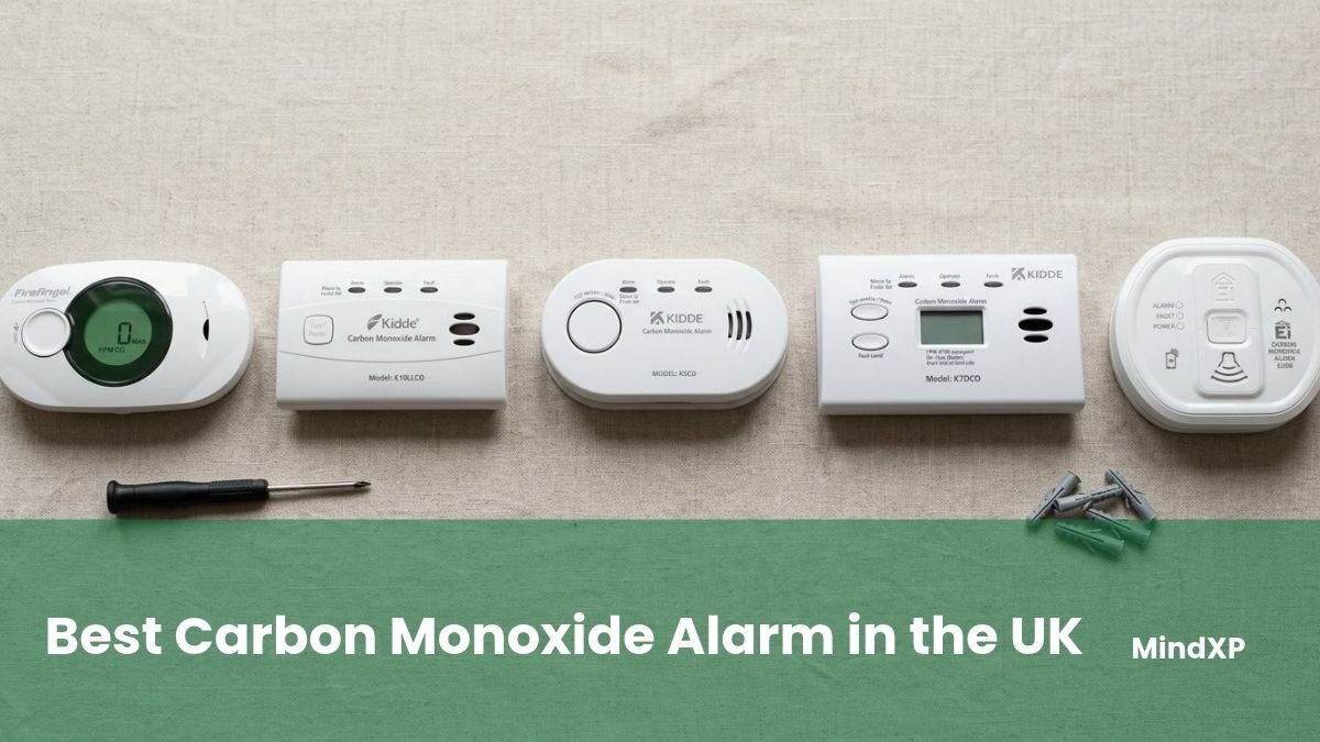 FireAngel, Kidde and Aico carbon monoxide alarms on linen with a screwdriver and wall plugs
